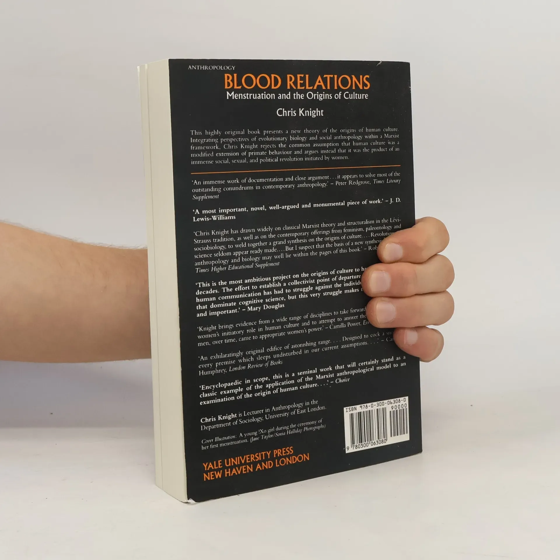 Back cover of "Blood Relations" by Chris Knight, showing review blurbs and a hand holding the book.